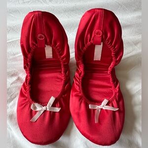 Red slippers with white bows